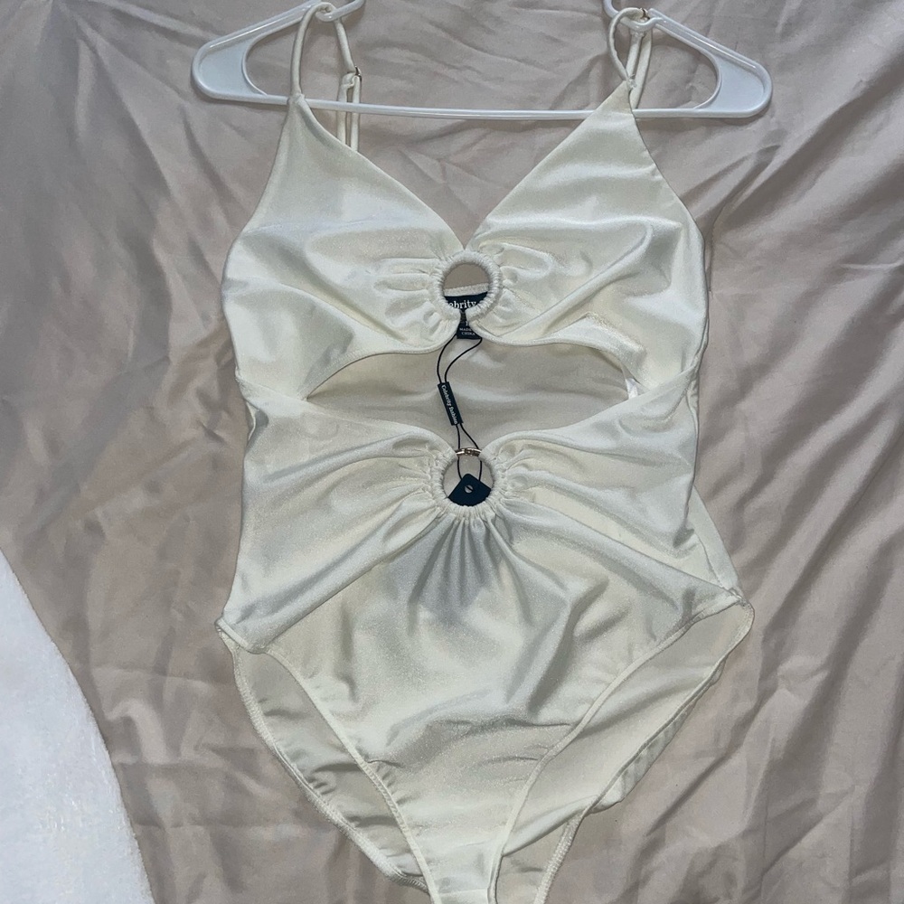 White bodysuit with gold ring accents
